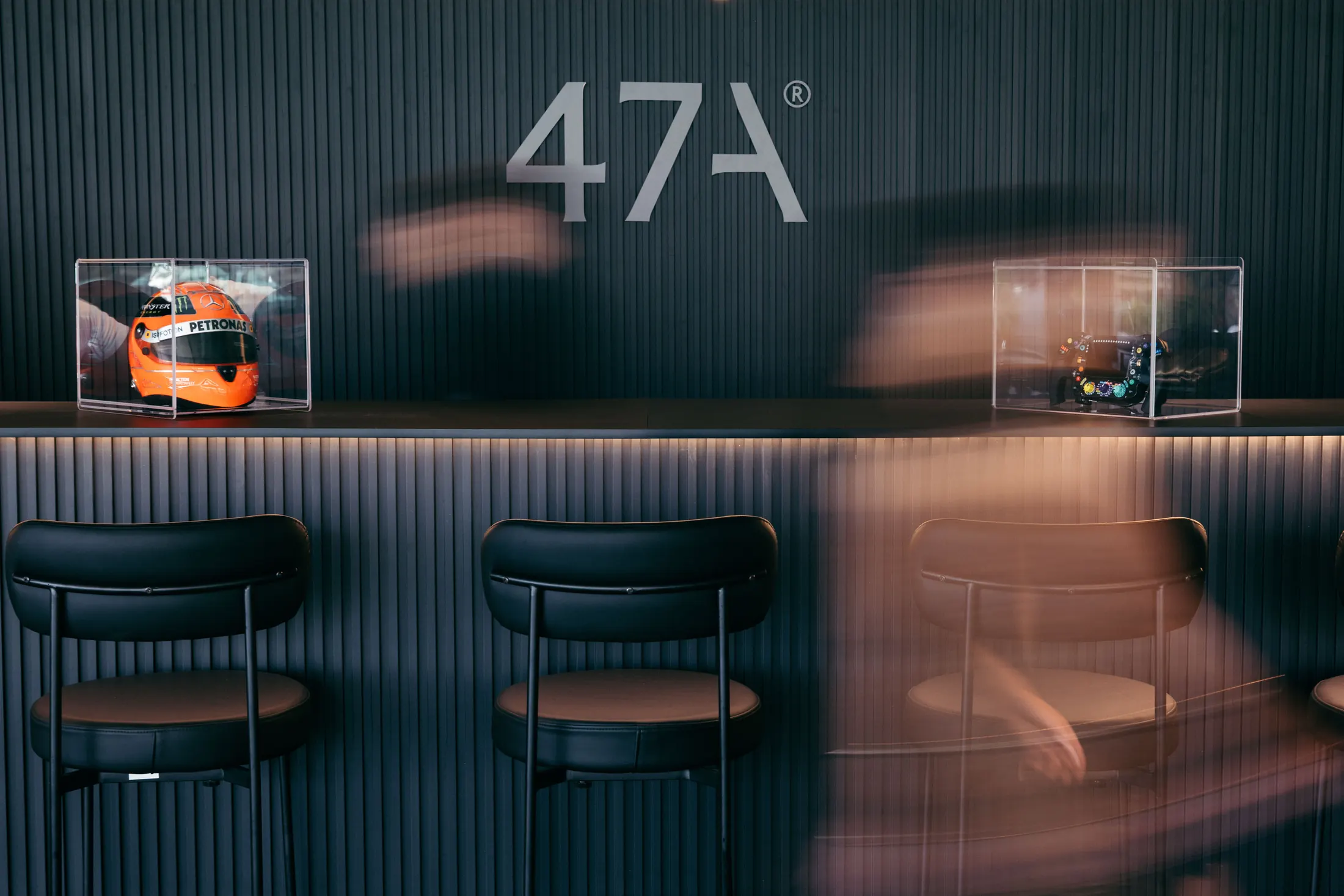 A racing helmet displayed beneath the 47A® mark inside the suite