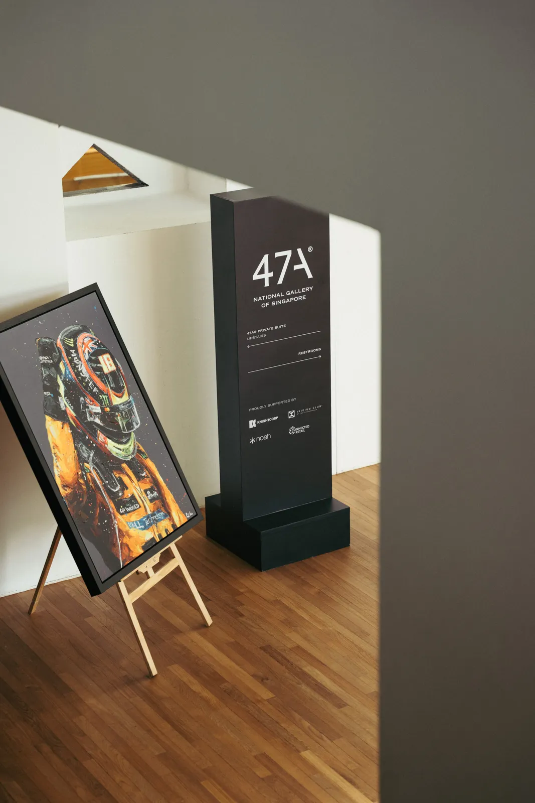 The 47A® totem inside National Gallery Singapore, beside racing artwork